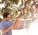 scientist holding object outside in the sun