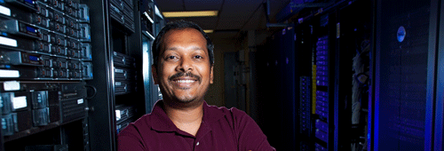 A SLAC employee next to a large computer