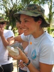 Student holding an alligator