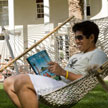 Student enjoying a magazine in the sun