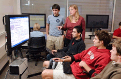 PWR instructor and students collaborate using a plasma screen in Wallenberg Hall