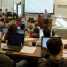 Professor at front of classroom talking with students