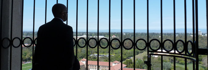 Student looking out from Hoover Tower