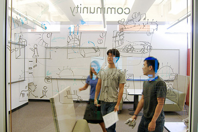 Students in front of line drawings on board. / Photo: Courtesy of Stanford Technology Ventures Program