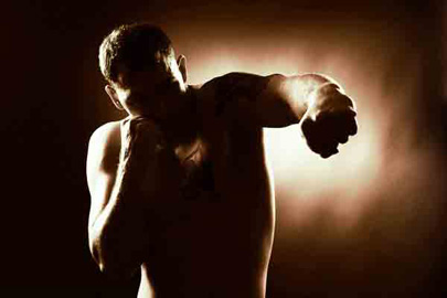 Sillouette of a man punching /Photo: Zemler, Shutterstock