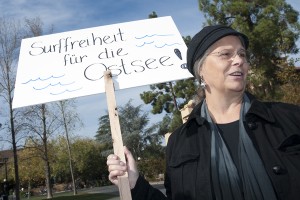 Karen Kramer, director of the Stanford-in-Berlin overseas studies program, held a protest sign at the event on White Plaza marking the 20th anniversary of the fall of the Berlin Wall.