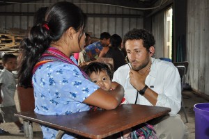 Stanford medical student Jake Rosenberg examines a six-month old diagnosed with pneumonia.     Photo: Adam Gorlick 