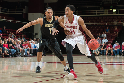 hoto of Stanford senior and men's basketball player Anthony Brown dribbling down the court and being guarded by a Vanderbilt player. Photo credit David Bernal/isiphotos.com