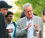 Photo – Jens Nørskov speaks with scientists during a SLAC catalysis symposium