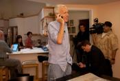 Photo - Brian Kobilka at home on cell phone, surrounded by journalists