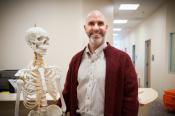 Photo - SLAC Nurse Practitioner Matt DeAngelis next to medical skeleton