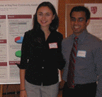 Two students presenting poster at reception