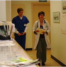 A patient advocate shadowing a doctor in clinic